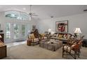 Bright living room with hardwood floors, stylish furniture, and access to the backyard at 1611 Walnut Ave, Winter Park, FL 32789