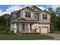 Two-story house with light brown siding, teal shutters, and stone accents at 16881 Muskgrass Dr, Winter Garden, FL 34787