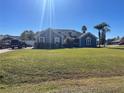 Two-story house with a green lawn and palm trees in front at 1901 Griff Wood Ct, Saint Cloud, FL 34772