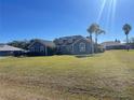 House exterior showcasing a spacious lawn and a clear sky at 1901 Griff Wood Ct, Saint Cloud, FL 34772