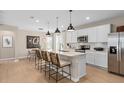 Modern kitchen with white cabinets, island, and stainless steel appliances at 1997 Tohoqua Blvd, Kissimmee, FL 34744