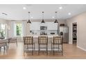 Modern kitchen with white cabinets, island, and stainless steel appliances at 1997 Tohoqua Blvd, Kissimmee, FL 34744