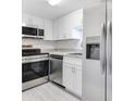 Modern kitchen with stainless steel appliances and white shaker cabinets at 200 Maitland Ave # 37, Altamonte Springs, FL 32701