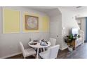 Bright dining area with a table and four chairs, and a view into the living room at 2219 Tongass Bnd, Davenport, FL 33896