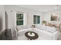 Bright living room featuring a white sectional sofa and a large TV at 3326 Thicket St, Tavares, FL 32778