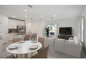 Kitchen and dining area with white round table and beige chairs at 3328 Thicket St, Tavares, FL 32778