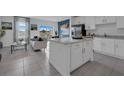 Open concept kitchen with island, granite countertops, and stainless steel appliances at 3328 Thicket St, Tavares, FL 32778