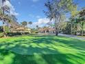 House with putting green, mature trees, and a large yard at 3415 S Mellonville Ave, Sanford, FL 32773