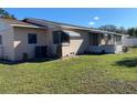 Side view of the house showing additional lawn space and AC unit at 3430 N Westmoreland Dr, Orlando, FL 32804