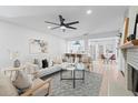 Open-concept living room with contemporary furnishings, including a modern fan and view to a kitchen bar at 417 Main Trl, Ormond Beach, FL 32174