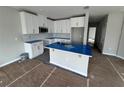 Modern kitchen featuring white cabinets and an island at 5100 Rain Shadow Dr, Saint Cloud, FL 34772