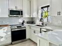 Modern white kitchen with stainless steel appliances at 631 Callahan St, Winter Park, FL 32789