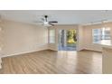 Bright living room with wood-look floors and sliding glass door to patio at 7240 Westpointe Blvd # 1115, Orlando, FL 32835