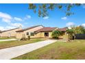 Two-unit home with a shared driveway, manicured lawn, and lush landscaping at 743 Golden Sunshine Cir, Orlando, FL 32807