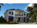 Two-story house with a blue roof, balcony, and palm trees at 749 S Atlantic S Ave, Ormond Beach, FL 32176