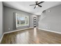 Living room with wood-look floors and large window at 7859 Summerlake Groves St, Winter Garden, FL 34787