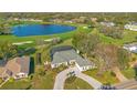 Beautiful aerial view of a home overlooking a peaceful lake and golf course, showcasing the property's serene setting at 8513 Bay Hill Blvd, Orlando, FL 32819