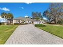 House exterior featuring a brick driveway and lush landscaping at 8513 Bay Hill Blvd, Orlando, FL 32819