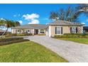 One-story home with paved driveway and landscaping at 8513 Bay Hill Blvd, Orlando, FL 32819