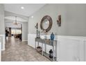 Bright and spacious entryway with tiled floors and decorative console table at 943 Gracie Ridge St, Clermont, FL 34715