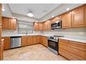 Updated kitchen featuring wood cabinets, stainless steel appliances, and quartz countertops at 958 Dunraven Dr, Winter Park, FL 32792