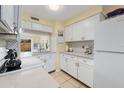 Bright kitchen featuring white cabinets, updated countertops, and modern appliances at 120 Georgetown Dr, Casselberry, FL 32707