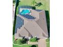 Aerial view of a home with solar panels and screened-in pool at 1855 Sugar Cove Ct, Ocoee, FL 34761