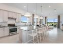 Spacious kitchen with island, stainless steel appliances, and granite countertops at 1933 Spring Shower Cir, Kissimmee, FL 34744