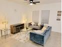 Living Room with gray couch, glass coffee table, and wooden media console at 2058 Derwent Dr, Davenport, FL 33896