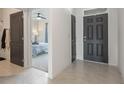 Bright entryway with tile flooring, leading to bedrooms and a living area at 2128 Silver Brook Way, Davenport, FL 33837