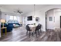 Open living and dining area with blue sofas and wood floors at 2300 Butterfly Palm Way # 205, Kissimmee, FL 34747