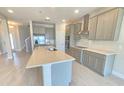 Bright kitchen features an island, stainless appliances, and sleek countertops at 2678 Great Heron Ave, St Cloud, FL 34773