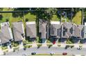 Aerial view of houses with solar panels and a tree-lined street at 2775 Red Horse Dr, Kissimmee, FL 34744