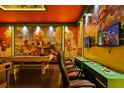 Game room with pool table, multiple gaming stations, and Mario theme at 3083 Mahalo Dr, Davenport, FL 33897