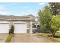 Two-story townhome with attached two-car garage and driveway at 3237 River Branch, Kissimmee, FL 34741