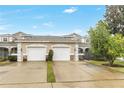 Two-story townhome with double garage and manicured lawn at 3237 River Branch, Kissimmee, FL 34741