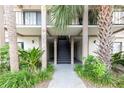 Condo building entrance with stairs and landscaping at 6039 Village Cir # Bldg C, Orlando, FL 32822