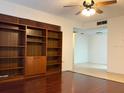 Bright living room with built-in shelving and hardwood floors at 6039 Village Cir # Bldg C, Orlando, FL 32822