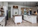 Spacious kitchen with island, white cabinets, and farmhouse sink at 720 Napoli Ln, New Smyrna Beach, FL 32168