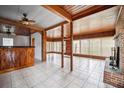 Spacious living room with wood paneling, fireplace, and tile floors at 120 Sunset Blvd, Polk City, FL 33868