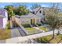 Quaint yellow house with a white picket fence and nicely landscaped yard at 123 N Hyer Ave, Orlando, FL 32801