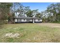 Newly built home showcasing curb appeal with a spacious yard at 1260 Lake Helen Osteen Rd, Lake Helen, FL 32744