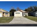 White one-story house with attached garage and small yard at 138 Meadow Blvd, Sanford, FL 32771