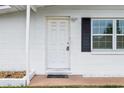 White front door with black shutters and stone accents at 1413 Evangeline Ave, Orlando, FL 32809