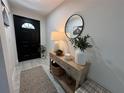 Bright entryway with console table, mirror, and decor at 1490 11Th Ave, Deland, FL 32724