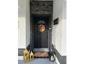 Black front door with stone accents and a welcome sign at 1490 11Th Ave, Deland, FL 32724