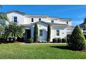 Stunning two-story home with modern design, manicured lawn, and palm trees at 15783 Tangerine Dream Ct, Winter Garden, FL 34787