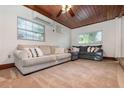 Bright living room with wood ceilings, comfortable sofas, and ample natural light at 1819 Paloma Ave, Sanford, FL 32771