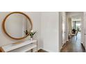 Bright and airy entryway with a large circular mirror and console table at 2215 Tongass Bnd, Davenport, FL 33896