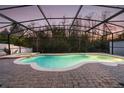 Screened pool with a brick surround and a serene, private backyard at 2555 Sand Arbor Cir, Orlando, FL 32824